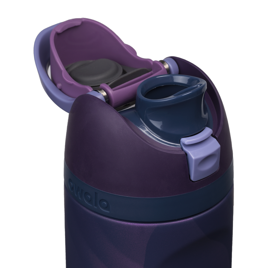 Owala FreeSip 24oz in Arctic Storm, close-up with the flip cap open showing the navy FreeSip spout with periwinkle accent